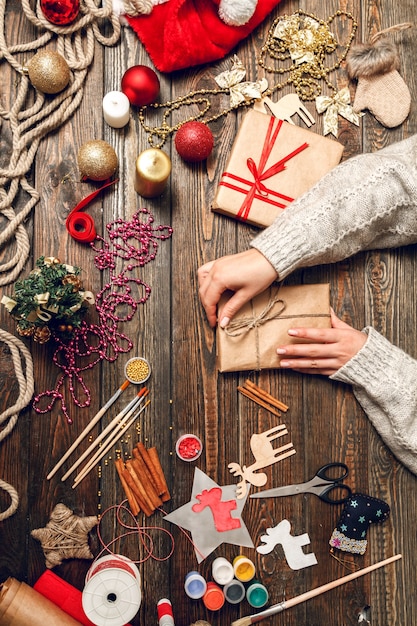 Woman decorate box with Christmas gifts