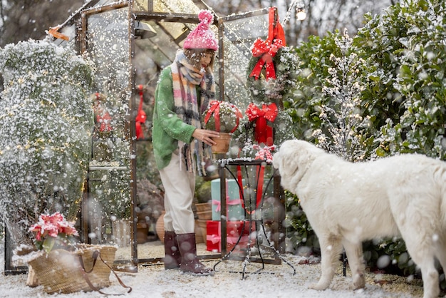 Woman decorates backyard for a winter holidays