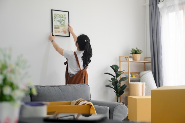 Woman decorating new home while moving in to new house or apartment