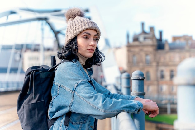 woman in denim jacket is talking on the phone and waiting for a tram bus at the stop Lifestyle photo