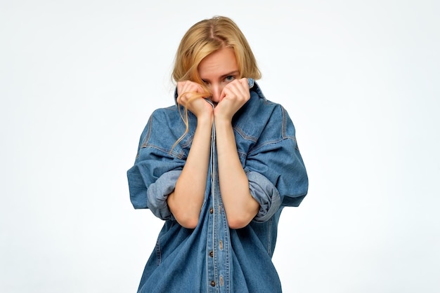 Photo woman in denim jeans shirt r hiding her face she wants to stay anonym