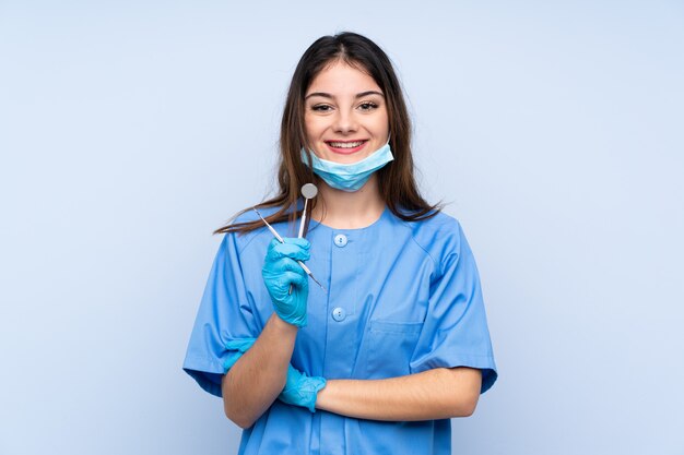 Woman dentist holding tools laughing