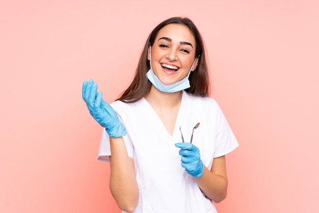 Woman dentist holding tools