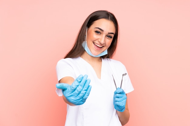 Woman dentist holding tools