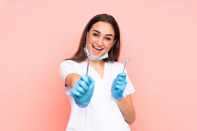 Woman dentist holding tools