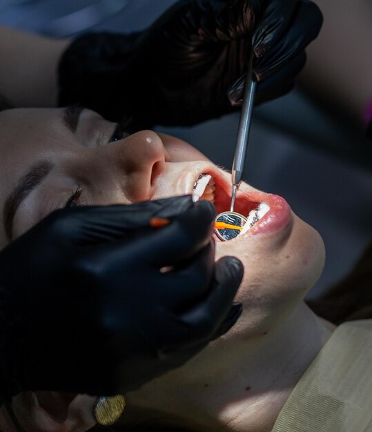 A woman at a dentist's appointment to replace arches with braces