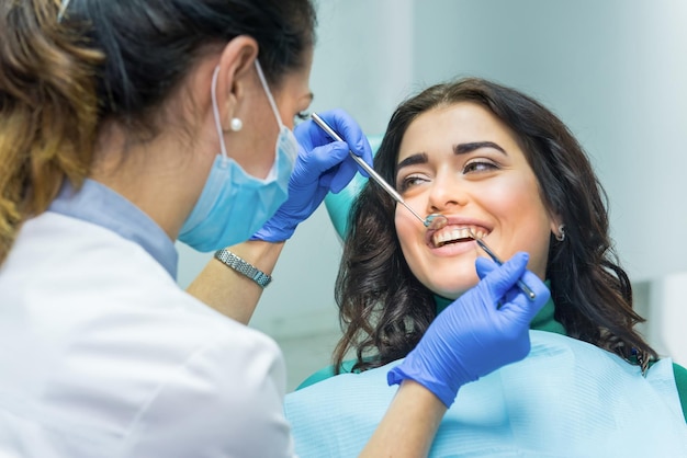 Woman at the dentist smiling Work of stomatologist with patient Make your smile perfect