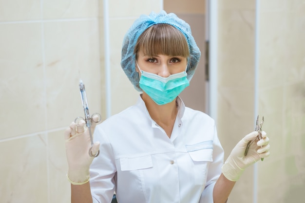 Woman dentist with tools in hand