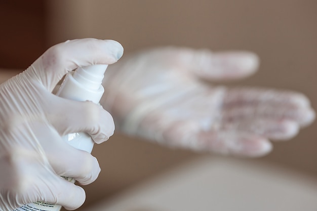 Photo woman desinfecting her hands before manicure procedure.