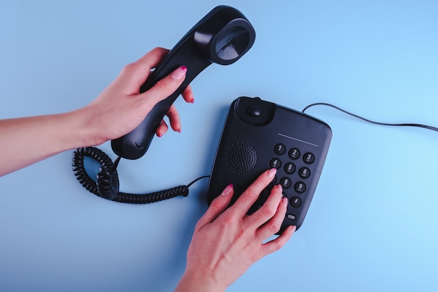 Photo woman dialing a number on old fashioned phone