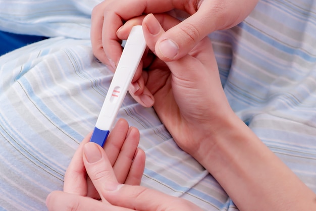 Woman discovering her positive pregnancy test