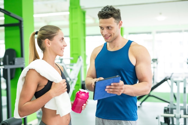 The woman discuss with a fitness instructor