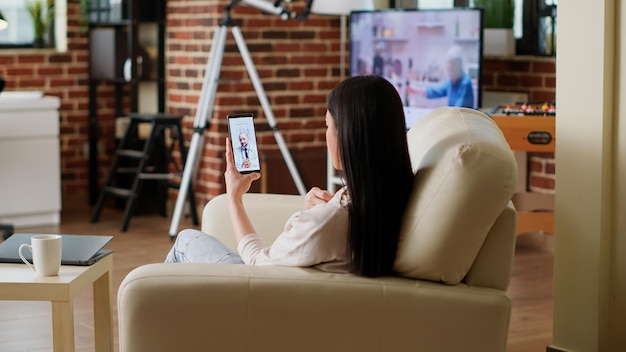 Woman discussing with general practitioner on computer digital\
call. patient getting virtual consultation through telehealth\
program while talking with doctor on online videocall on mobile\
phone.