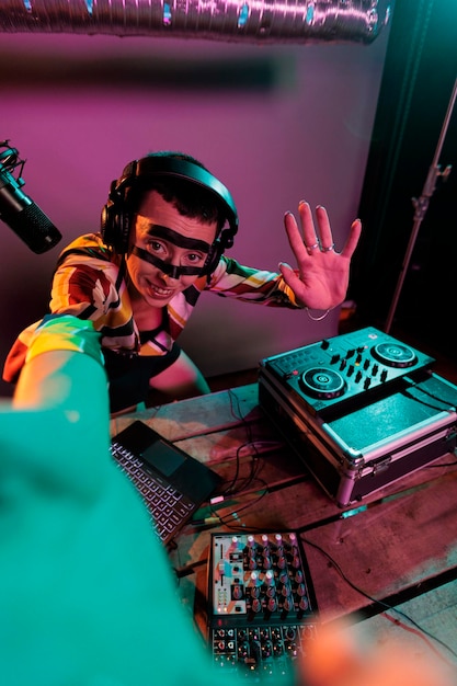 Woman dj artist mixing sounds on turntables, using buttons and\
bass key to mix techno music. musician performing with mixer at\
nightclub, using electric control panel, disc jockey.