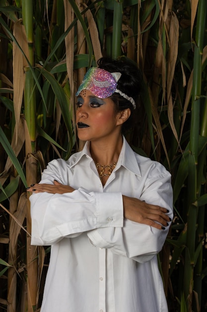 woman doctor disguised with her arms crossed with bamboo plants in the background