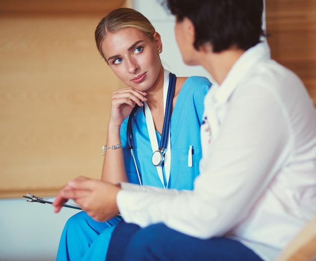 Woman doctor explaining diagnosis to her female patient