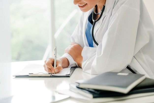 Woman Doctor and Female Patient in Hospital Office