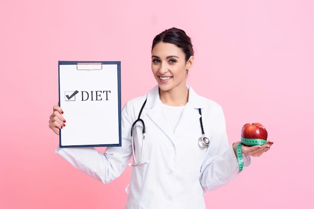 Woman Doctor Holding Apple, Measuring Tape and Diet Sign