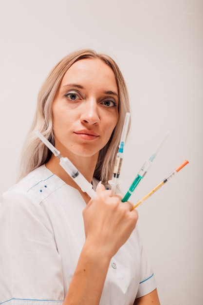 Woman doctor holding syringes with vaccine