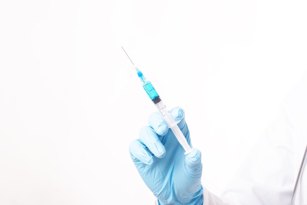 A woman doctor holds a syringe in front of the ward