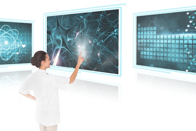 Photo woman doctor interacting with medical interfaces against white background