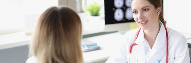 Woman doctor measuring patient blood pressure in clinic