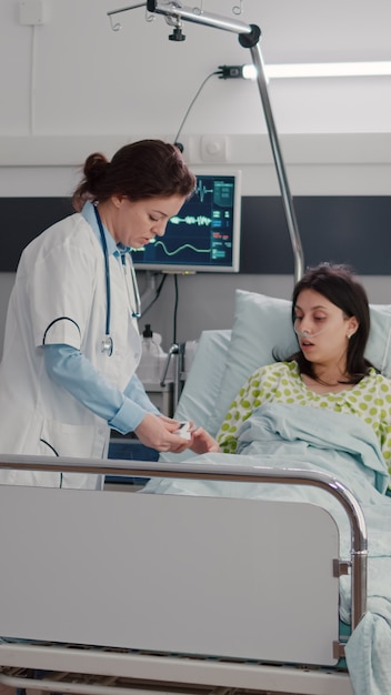 Woman doctor monitoring sick woman during rehabilitation appointment