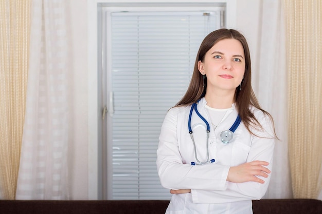 Woman doctor or nurse standing with stethoscope