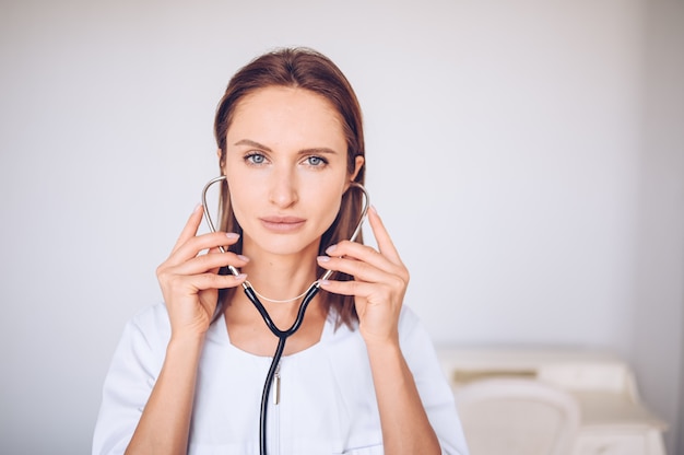 Woman doctor nurse with stethoscope for check breathing