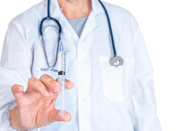 Woman in a doctor's coat injects medicine from a syringe isolated