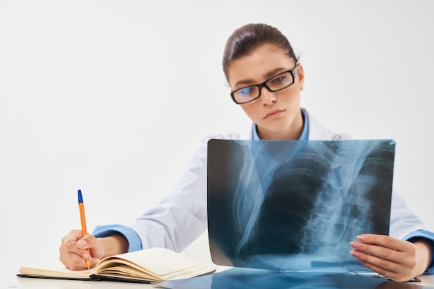 Woman doctor sitting at the table radiologist diagnostics professionals