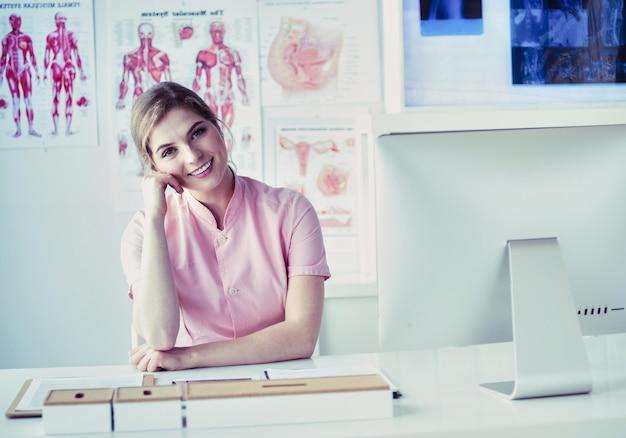 Woman doctor sitting with folder at hospital