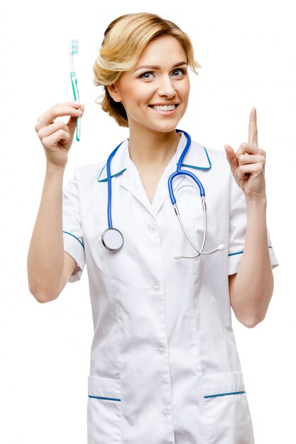 Woman doctor standing on white background