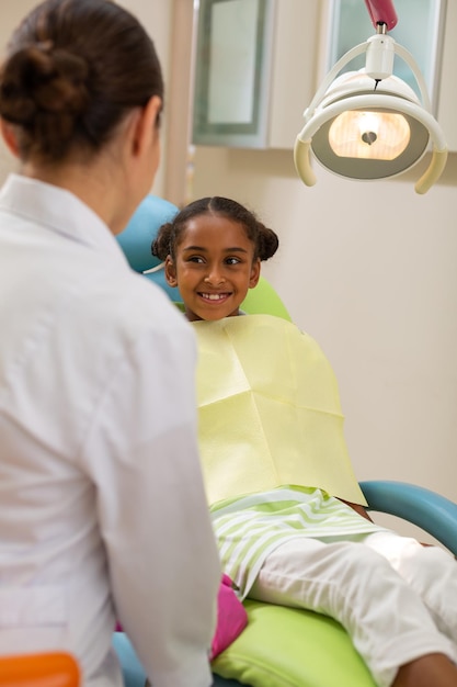 Woman doctor talking to a happy female patient