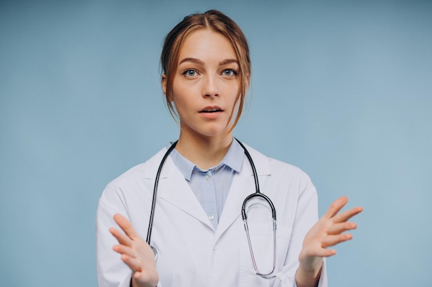 Woman doctor wearing lab coat with stethoscope isolated