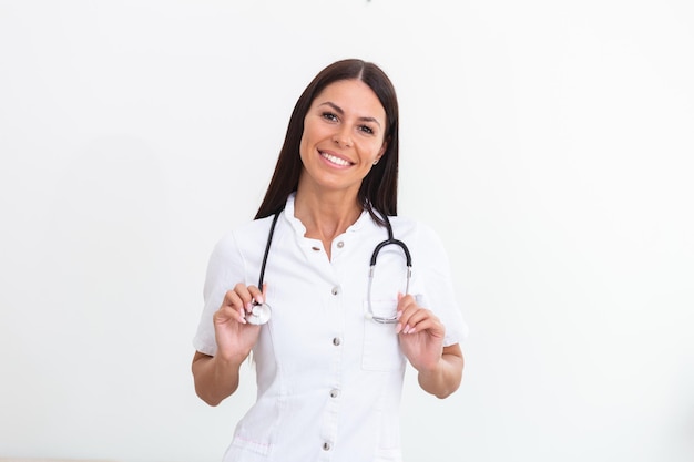 Woman doctor wearing white coat stethoscope on shoulders looking at camera. Confident female doctor smiling at camera, health care and prevention concept