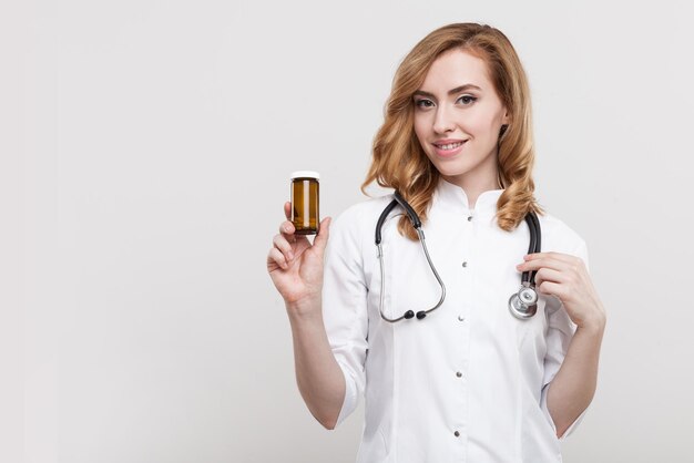 Woman doctor with pill jar