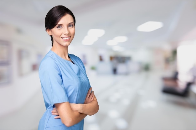 Woman doctor with stethoscope on background