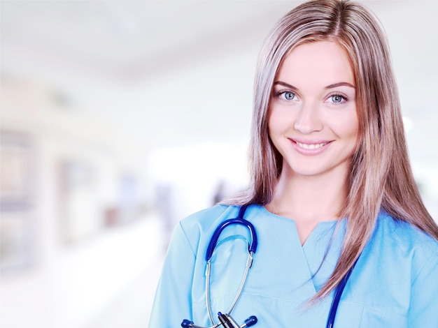 Woman doctor with stethoscope on background