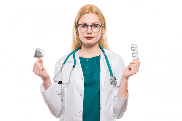 Woman doctor with stethoscope hold contraceptives