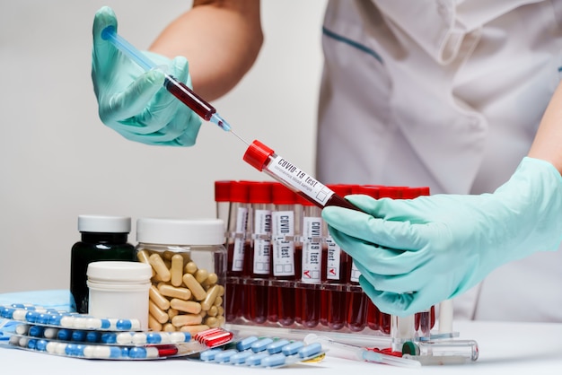 Woman docxtor working with blood test tubes