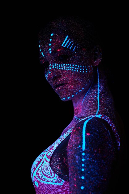 Woman does yoga, hand movement, body warm-up. art girl cosmos\
in ultraviolet light. entire body is covered with colored\
droplets