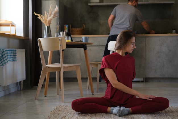 A woman does yoga at home.