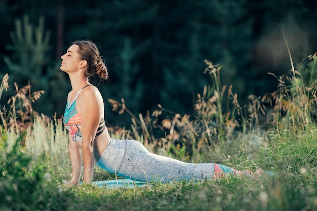 A woman does yoga in the open air The concept of sport