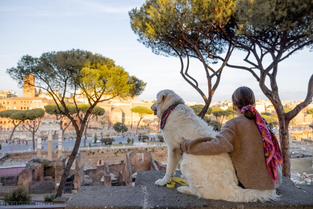 Woman and dog enjoying beautiful view from above on the old centre of Rome