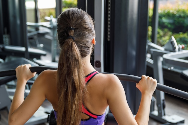 Woman doing exercise for her back - Lat pulldown