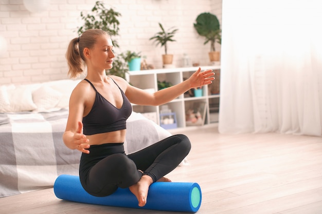 Woman doing exercise on a special simulator balancer. Balance training.