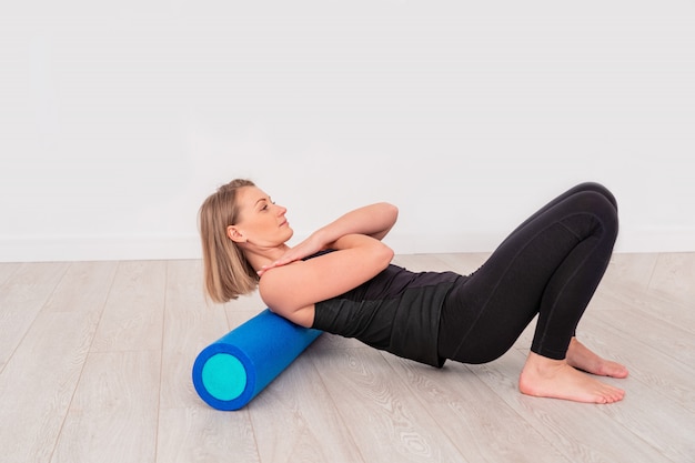 Woman doing exercise with a roller