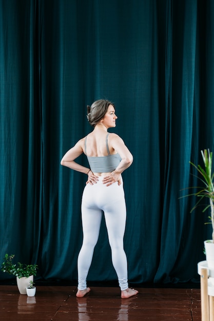 woman doing exercises stretching back arms and legs