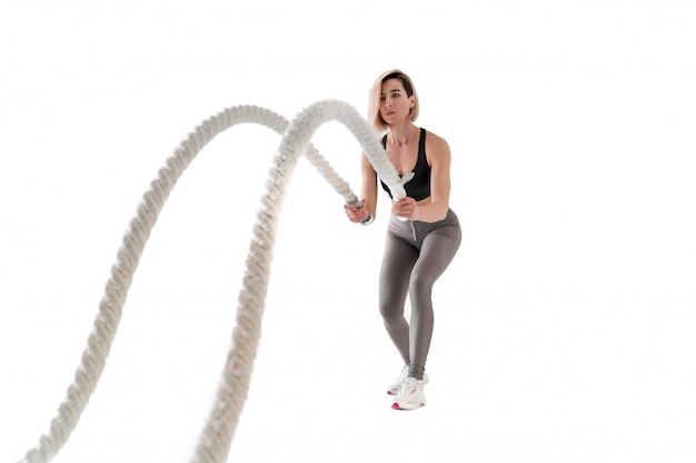 Woman doing exercises with battle rope